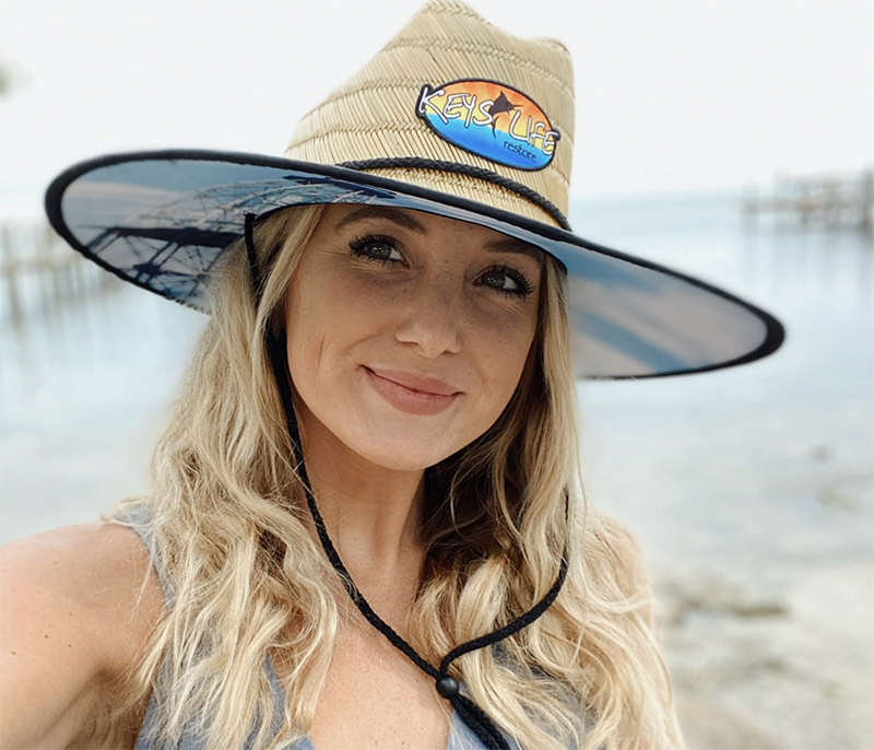 Happy customer wearing their custom hat created through Tiki Island Wear