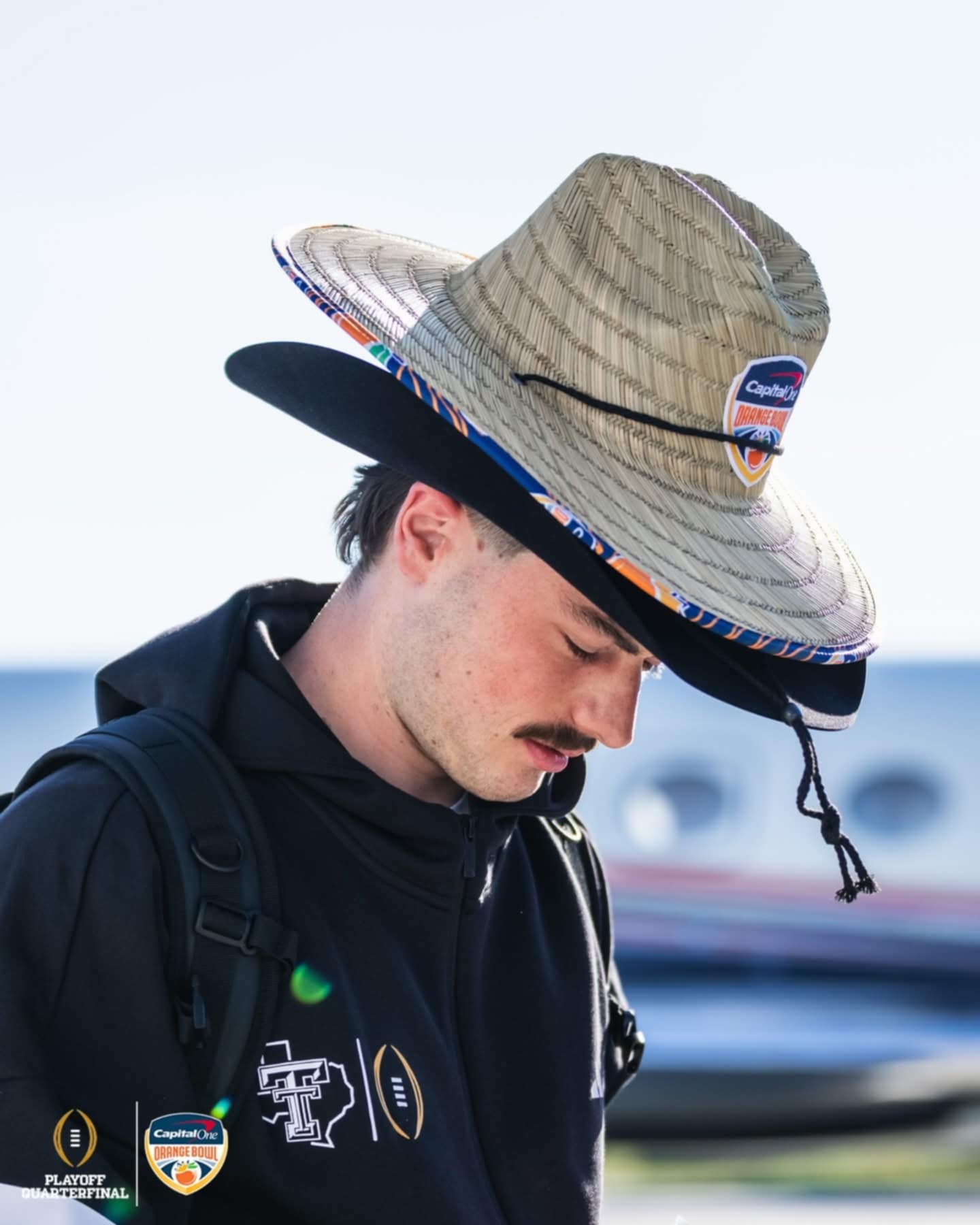 Capital One Orange Bowl arrival gifts featuring tropical-style custom straw hats