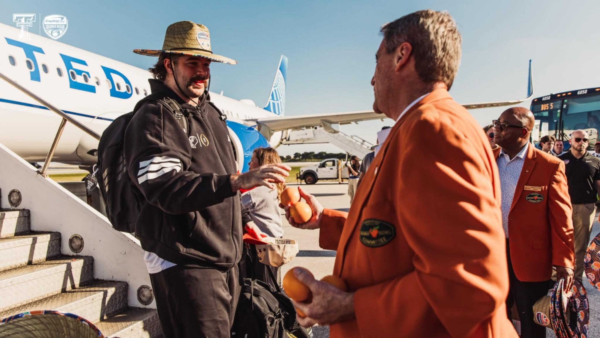 Tropical custom straw hats presented as arrival gifts at the 2026 Capital One Orange Bowl